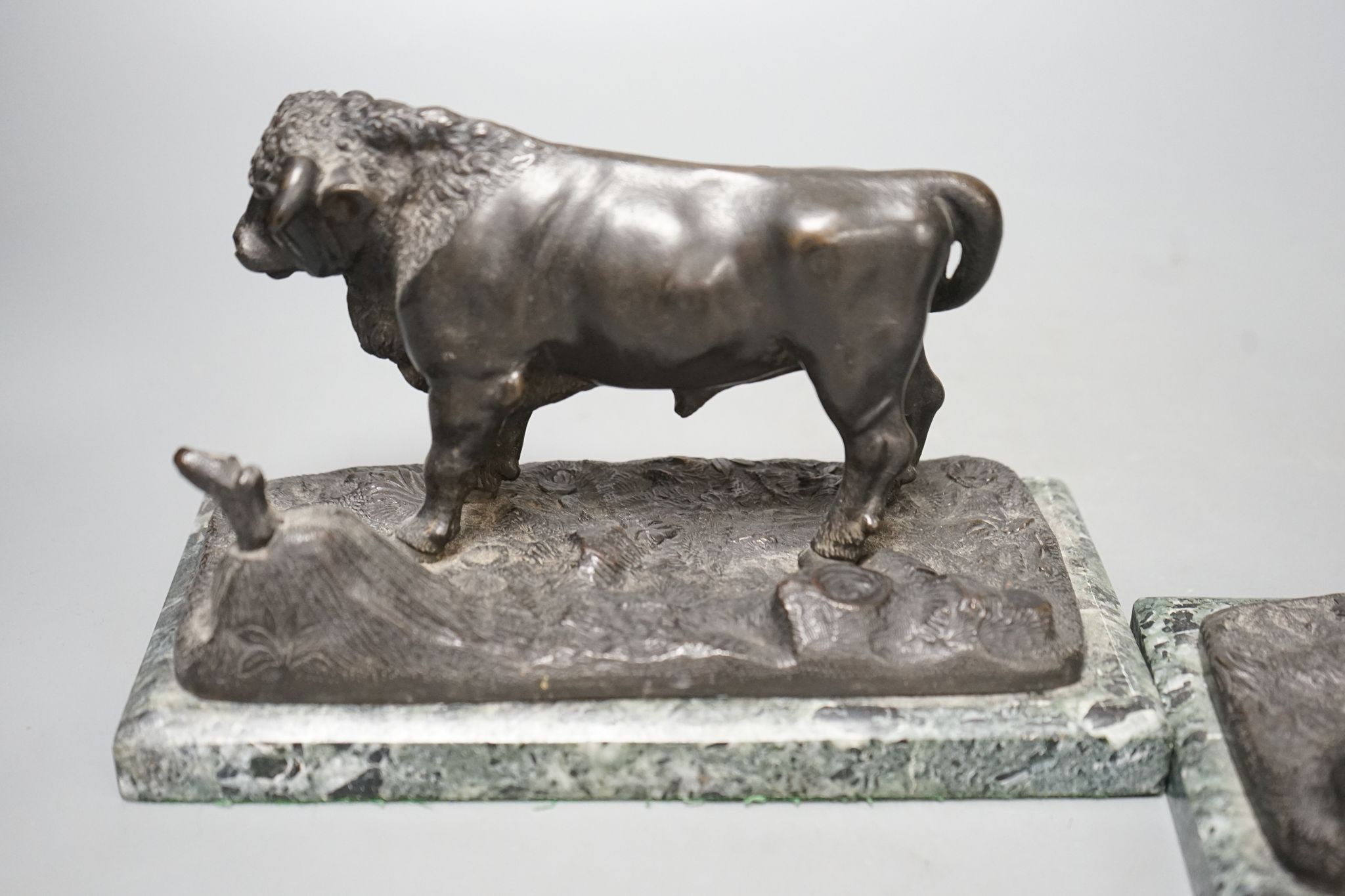 A pair of 20th century bronzes, a cow and a bull, on marble bases, 21cm